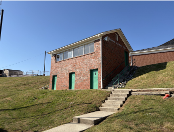 Photograph of the brick A.L. Brown school building exterior with a grass field.